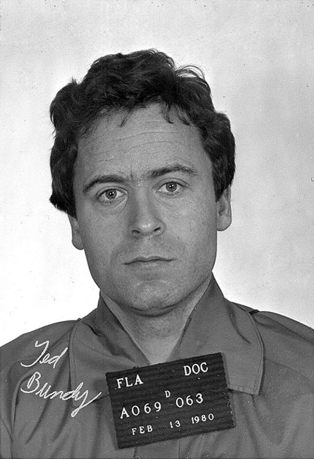 A black and white mugshot of Ted Bundy