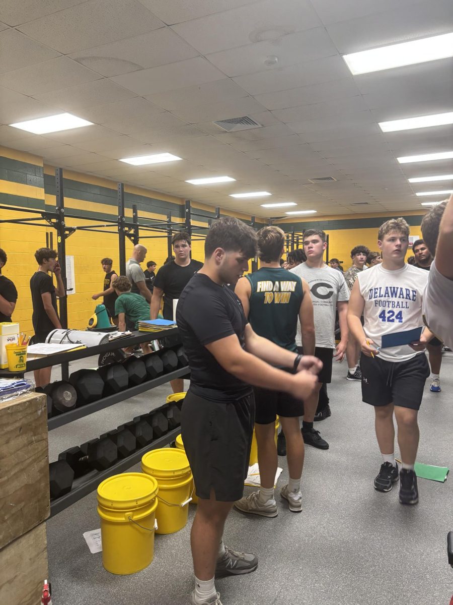 Pioneer football team working out in the weight room.